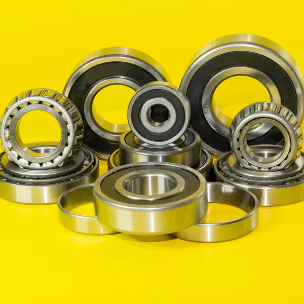 Various ball bearings arranged on a yellow background.